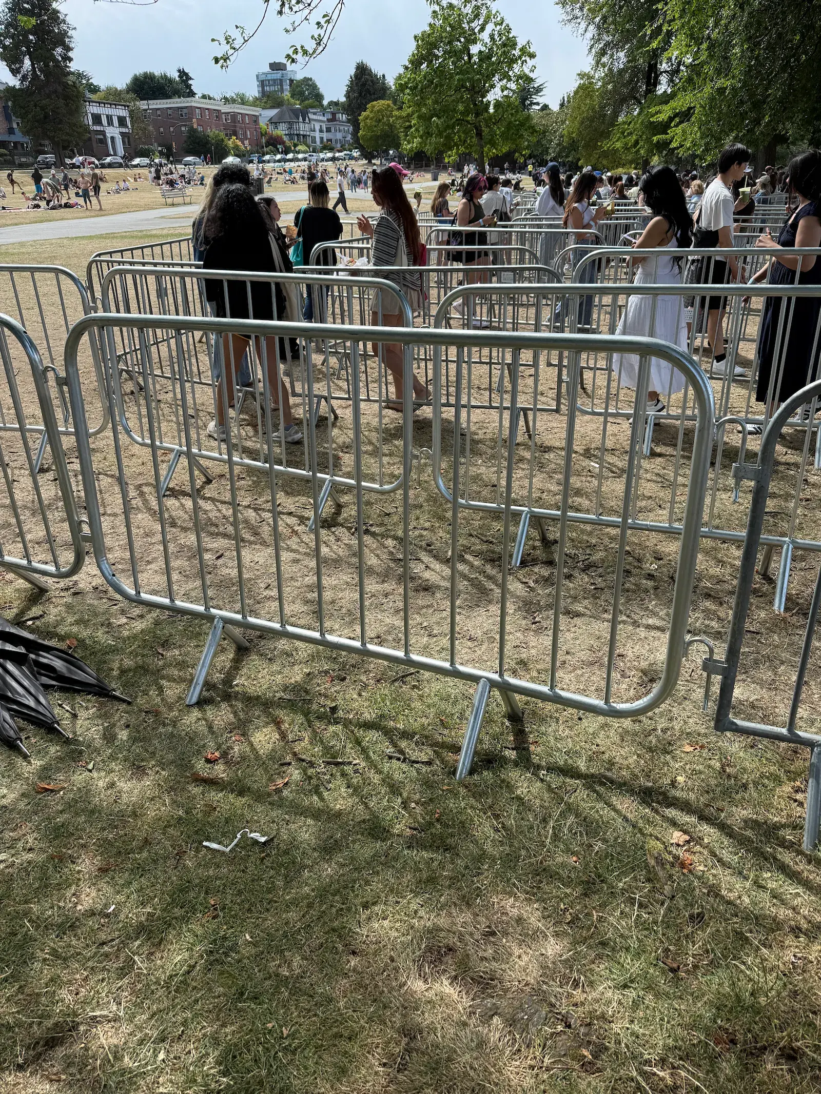 Steel crowd control barricades forming a narrow entrance lane at a Toronto event.