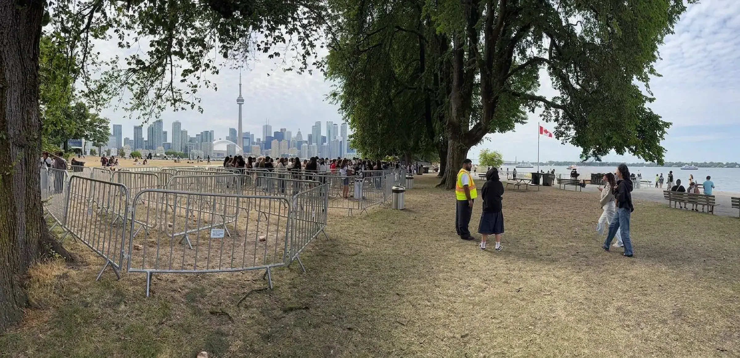 Galvanized steel crowd control barriers set up in a line at an outdoor event in Toronto.